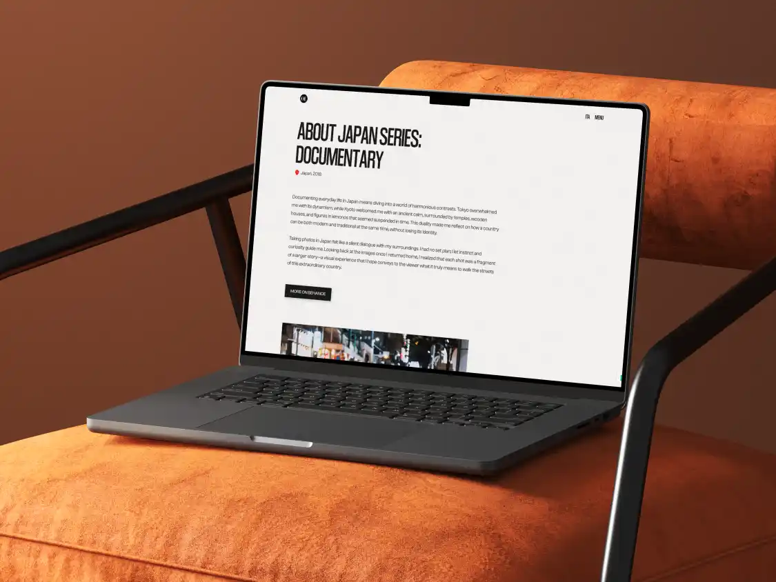 Open laptop on an orange cushioned chair showing a webpage titled 'About Japan Series: Documentary' with text describing photography in Japan.